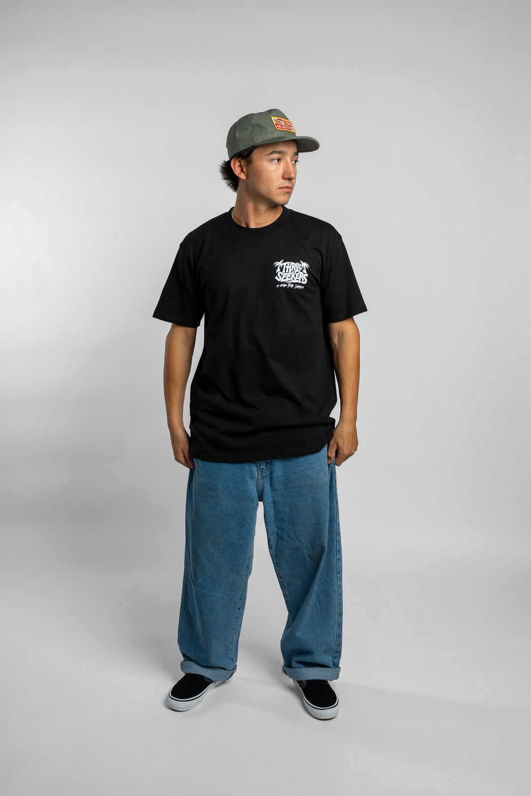 Person wearing black tee with 'Thrill Seekers' good time supply logo in white