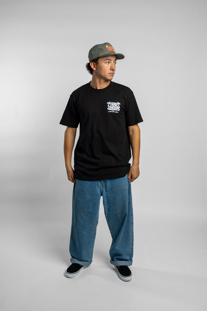Person wearing black tee with 'Thrill Seekers' good time supply logo in white