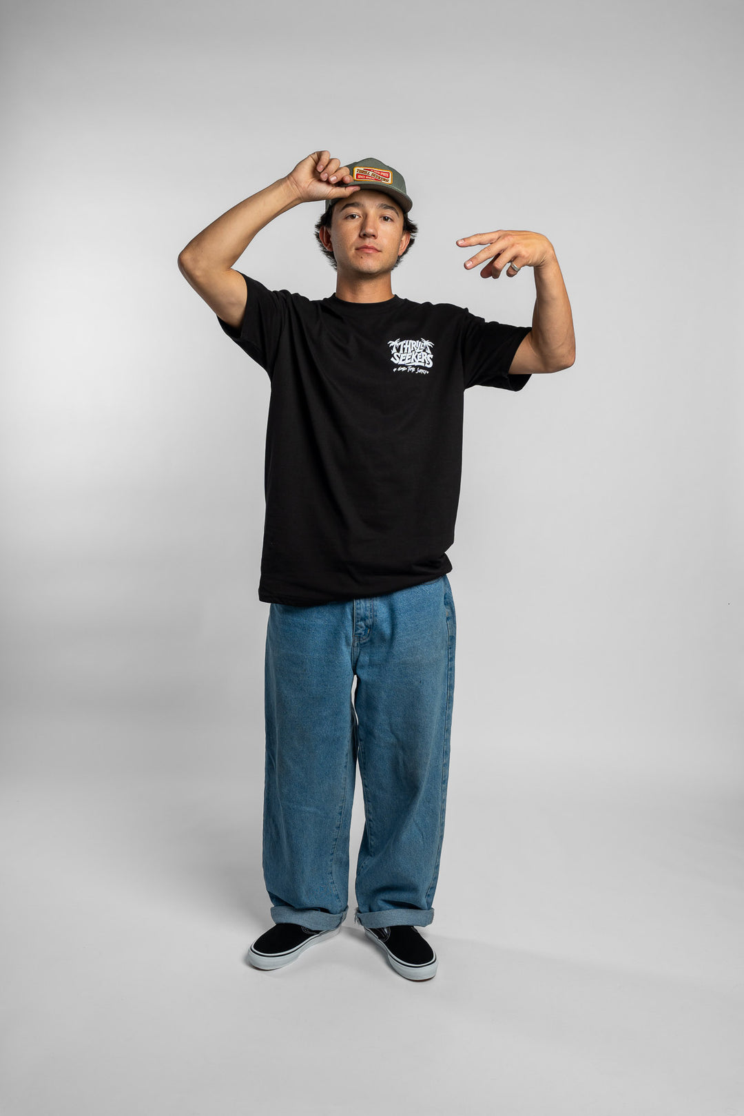 Person wearing black tee with 'Thrill Seekers' good time supply logo in white